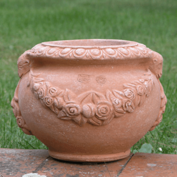 Blumenvase mit Rosen und Widderköpfen